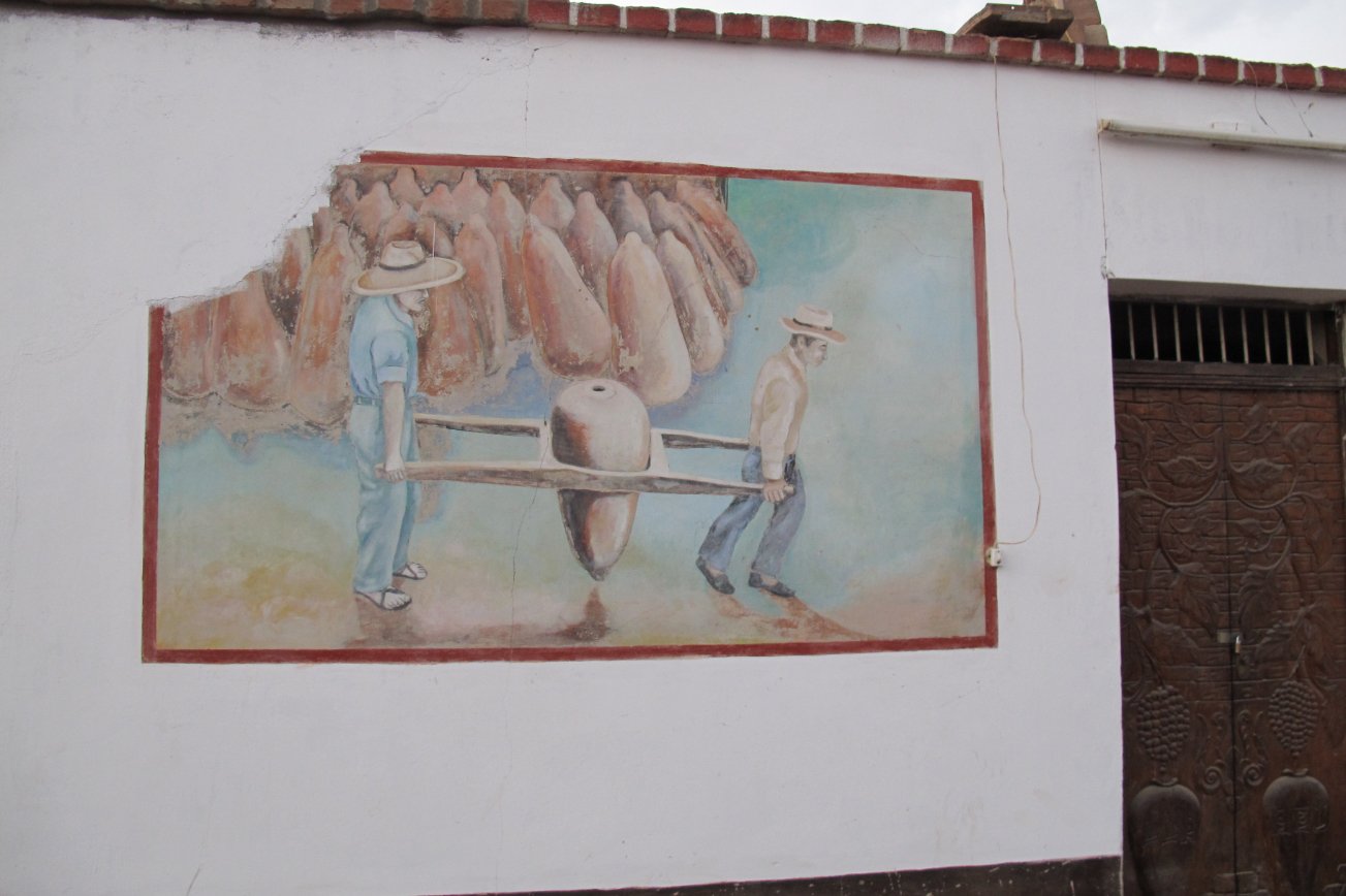 Lovera Distillery Pisco Peru painting carrying botijas